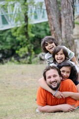 Fototapeta premium Happy family lying on meadow in nature