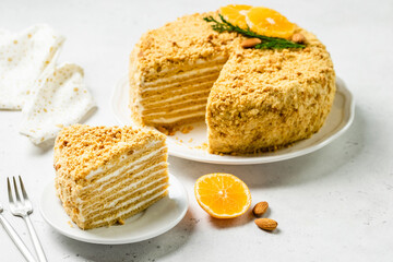 Almond honey cake sour cream frosting on plate. Space for text.