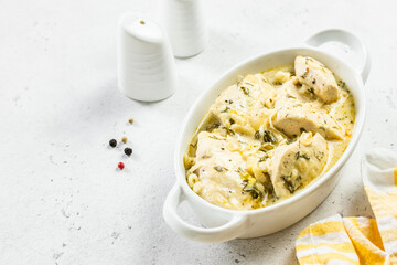 Chicken fillet dijon cream sauce in ceramic dish. Space for text.