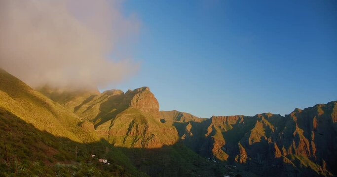 Beautiful mountain peak in clouds. Sunset on the gorge Mask or Masca village. Clouds descend on the gorge.