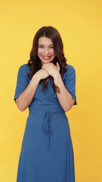 Exciting surprise. Wow unbelievable. Winner people. Astonished shocked enthusiastic lucky cheerful brunette woman in blue dress isolated on bright yellow vertical background set of 2.