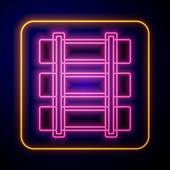Glowing neon Railway, railroad track icon isolated on black background. Vector