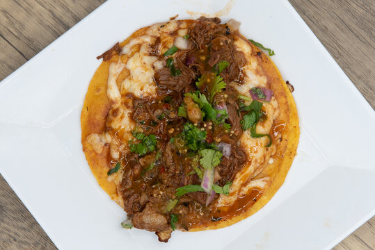 Overhead View Of Appetizing Birria Taco With All The Toppings  For A Tempting Mexican Food Delicacy