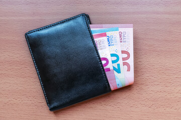 Euro banknotes in the wallet. Leather wallet with 10, 20 and 50 euro banknotes inside