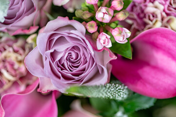 Hand tied exquisite bouquet features antiqua carnations, elegant Calla Lilies, Roses and fragrant Eucalyptus.
