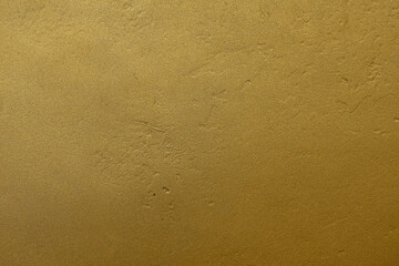 Fototapeta na wymiar Gold background. Gilded wall texture with a rough plaster pattern