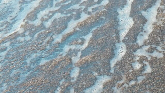 The inscription on the sand washes away with a wave. Bitcoin. Summer, sea, beach.