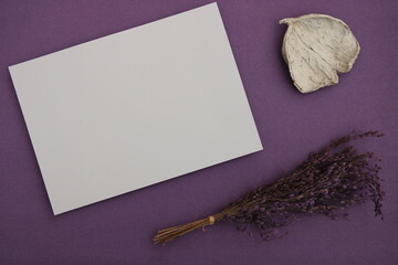 White card with space to write text on with purple background with a sprig of lavender and a white...