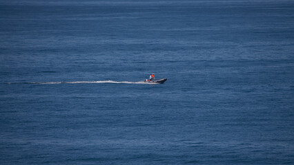 lifeboat running fast to check possible incident at huge and big ocean in Guincho, Cascais, Portugal.