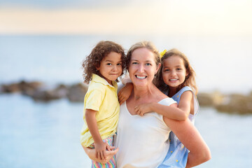Fototapeta na wymiar Mother and kids on tropical beach.
