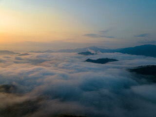Sunrise over sea of clouds and mountain peaks