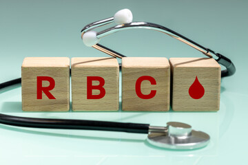 wooden blocks with the words RBC, red blood cells, count,  corpuscles, Medical stethoscope, concept...