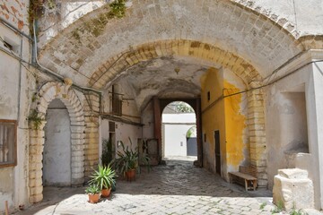 A narrow street between the old houses of Galatina, an old village in the province of Lecce in Italy.