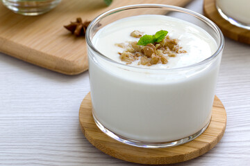 milkshake with walnut pieces and a sprig of fresh mint. gealthy eating