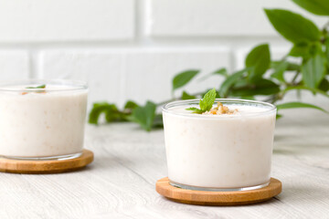 milkshake with walnut pieces and a sprig of fresh mint. gealthy eating