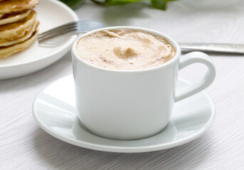 a cup of aromatic coffee on a light background close-up