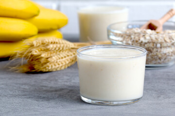milkshake on the background of cereal flakes and ripe bananas