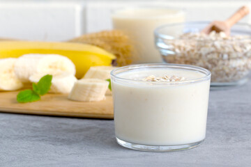 milkshake on the background of cereal flakes and ripe bananas