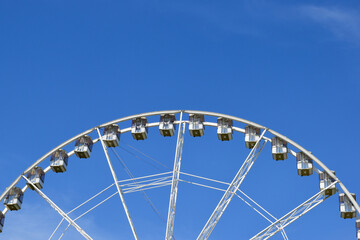 giant ferris wheel detail. white gondolas. steel frame construction. giant spokes in large wheel....