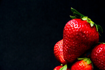 Fresh strawberries on black background