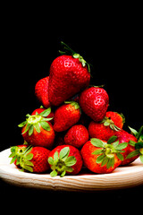 Fresh strawberries on black background