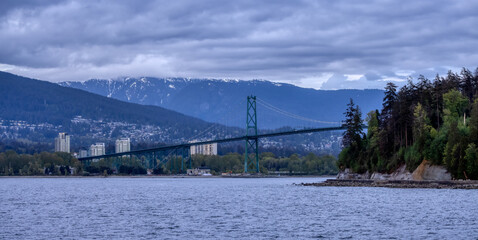 Lions Gate Bridge in a modern city on the West Coast of Pacific Ocean. Vancouver, British Columbia, Canada.