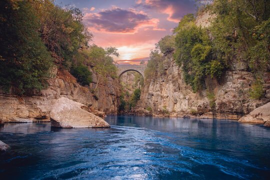 Ancient arch bridge Oluk over Koprucay river Tazi Canyon in Manavgat Antalya Turkey sunset