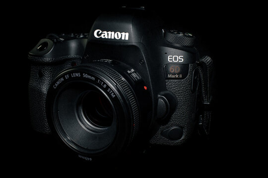Canon EOS 6D Mark II camera on black background with 50 mm lens