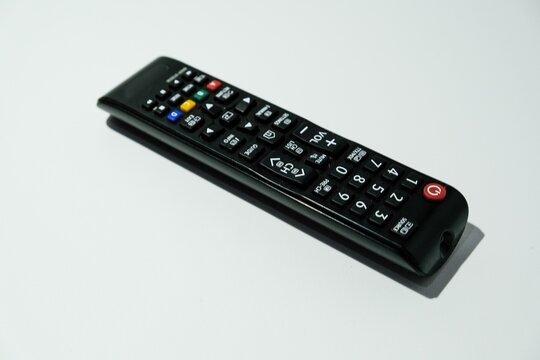 top angle view of a black tv remote control isolated on white background