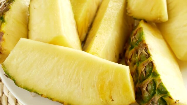 Freshly sliced pineapple on a plate.