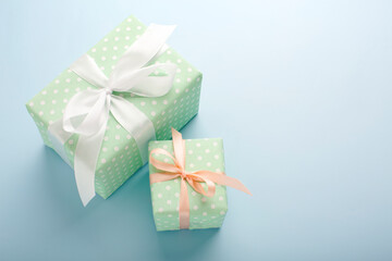 Present boxes on blue background greeting card holidays concept.