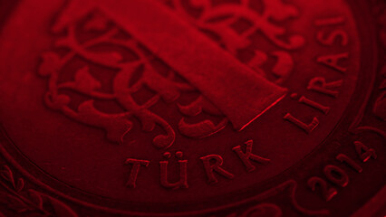 Translation: Turkish lira. Fragment of Turkish 1 one lira coin close-up. National currency of Turkey. Red tinted money wallpaper. Dark background for news about economy or finance. Macro