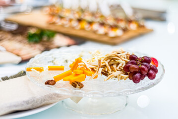 Appetizer plate: Cecil cheese,  grapes, walnuts, pecan, cheddar. Catering serving.