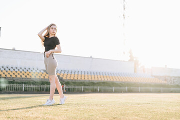 Full Length Slender Girl at the Stadium Sunset Summer Evening