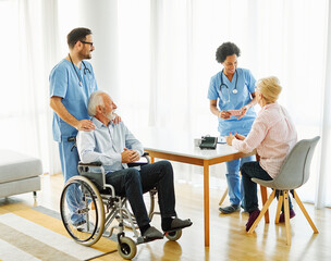 nurse doctor senior care caregiver help assistence wheelchair retirement home nursing elderly woman...