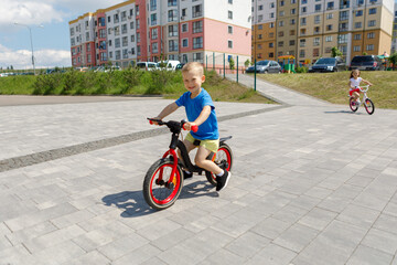 boy riding a bike on the street. Learning to ride a bike concept