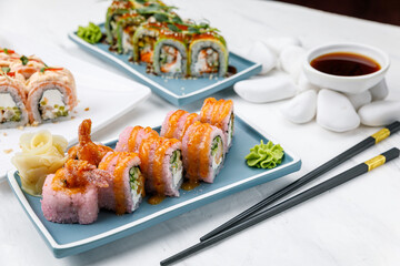 Japanese cuisine. Rolls with salmon on a white table.
