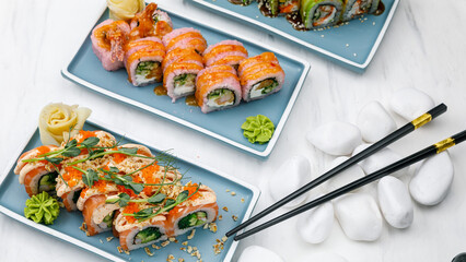 Japanese cuisine. Rolls with salmon on a white table.
