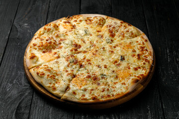 Italian cuisine. Pizza on a black table
