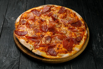 Italian cuisine. Pizza on a black table
