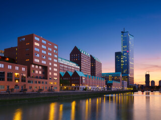 Rotterdam, Netherlands. View of the city center. Cove and pier for boats and ships. Panoramic view. Cityscape in the evening. Skyscrapers and buildings. - obrazy, fototapety, plakaty