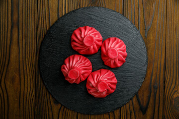 Georgian cuisine. Hinkali in plates on a wooden table
