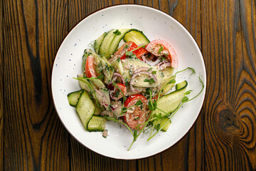 European cuisine. salad on a wooden table
