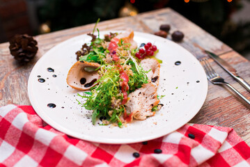 turkey filet salad with couscous, frisée lettuce salad leaves, balsamic sauce and red currant dressing