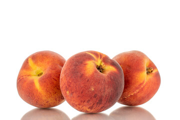 Fototapeta na wymiar Three sweet organic peaches, close-up, isolated on white background.