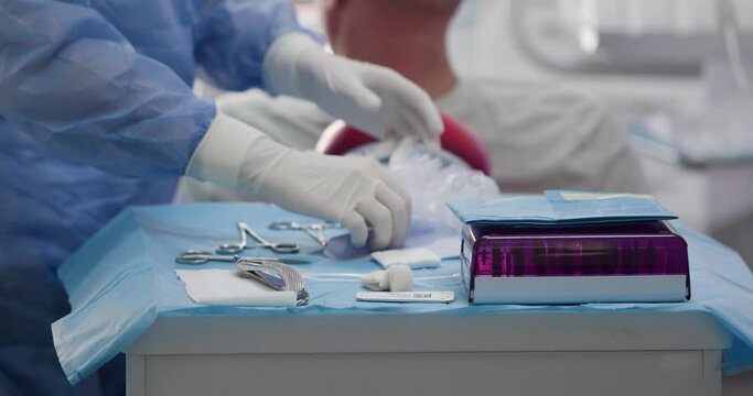 dental assistant chooses instruments for treatment in a medical cabinet. High quality 4k footage. Slow motion