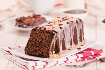 Sponge cake with white frosting and sugars.