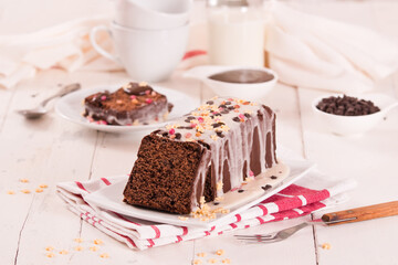 Sponge cake with white frosting and sugars.