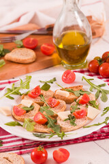 Friselle with cherry tomatoes and arugula.