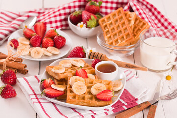 Waffles with strawberries, bananas and honey.